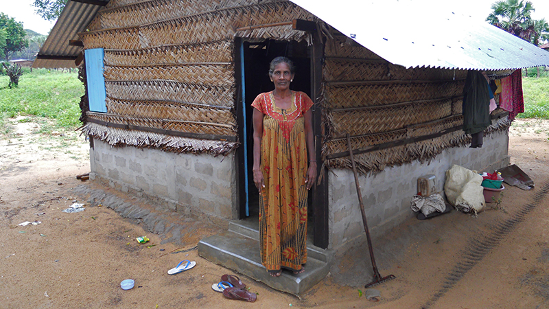 Woman in front of simple residential house