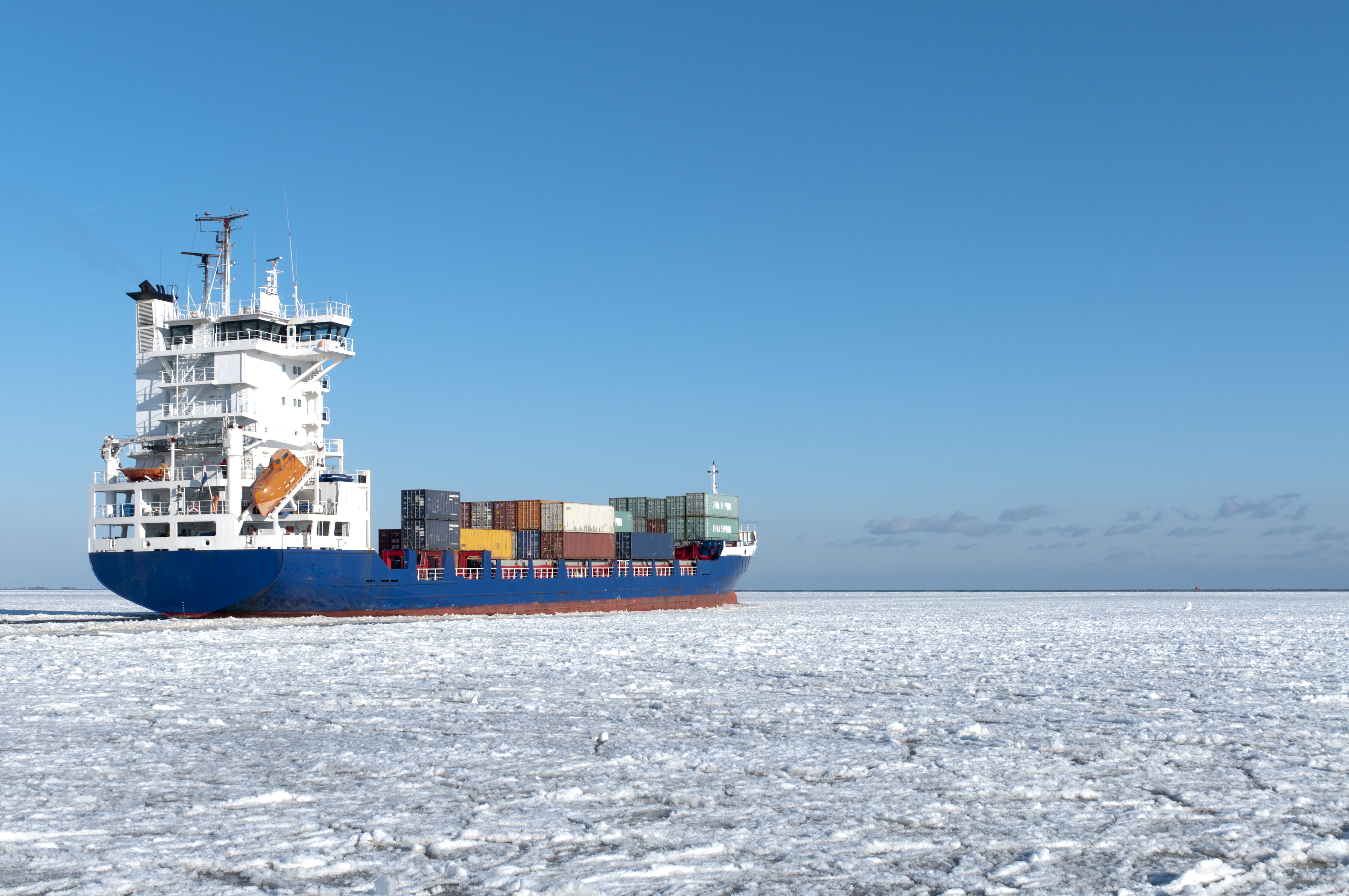 A picture of a containership frozen in place on the sea.  