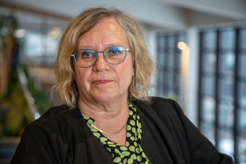 Portrett av ei kvinne i eit atrium.