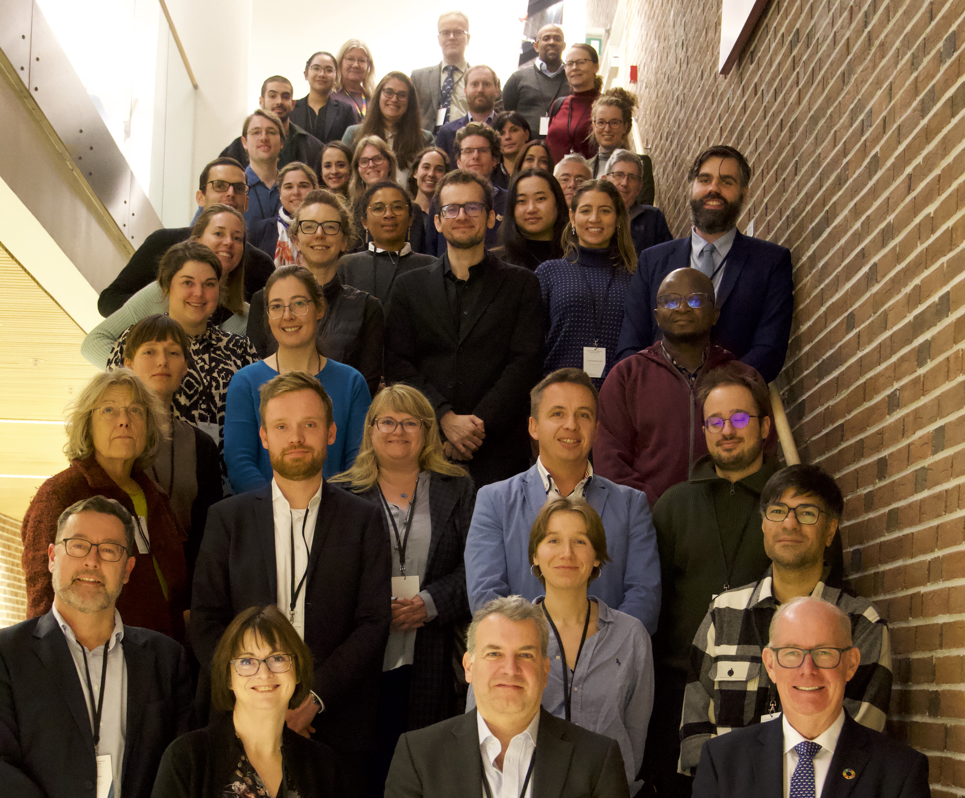 A picture of everyone attending the conference in a stairway.