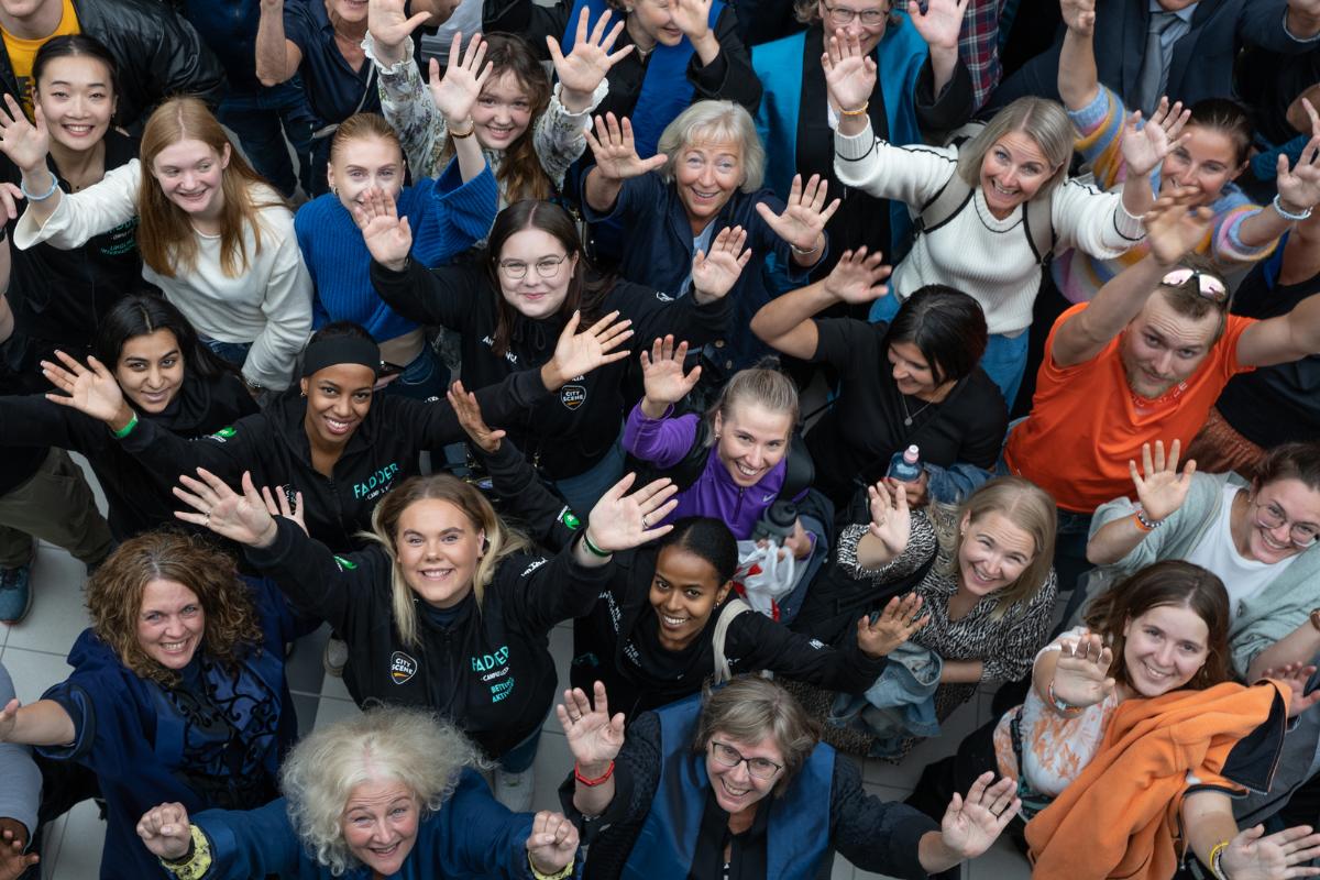 studenter og ansatte som rekker hendene opp i v&aelig;ret