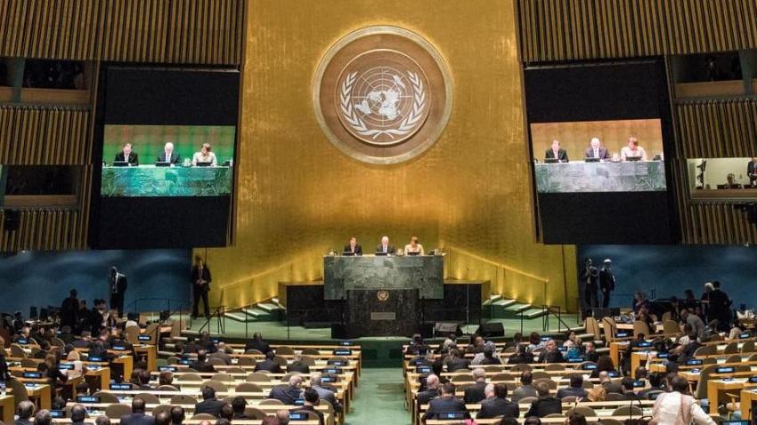 People sitting in a large conference hall.