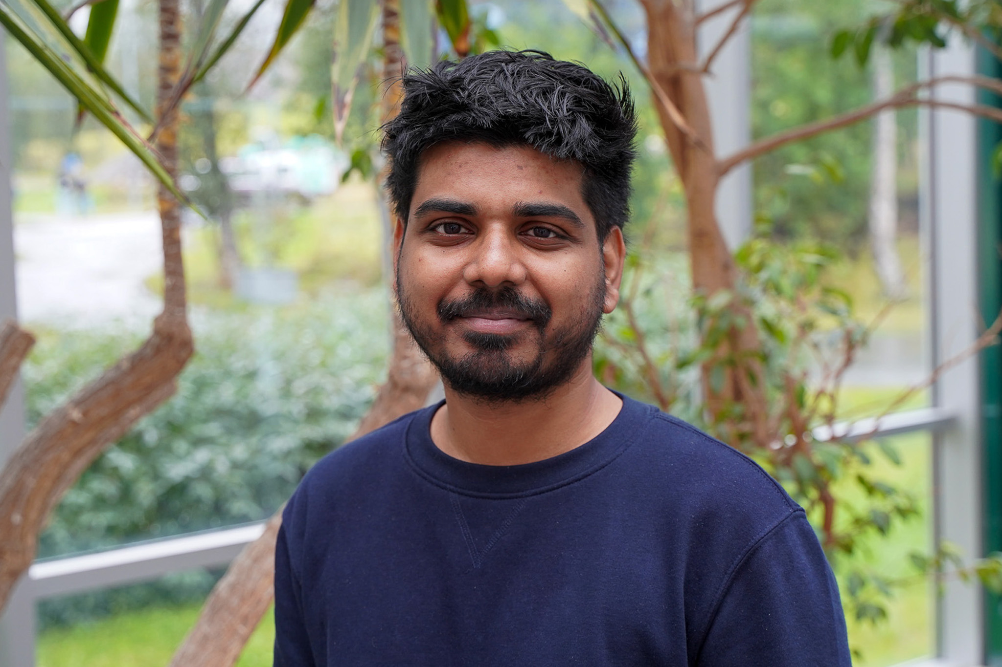 A man looks at the camera while smiling