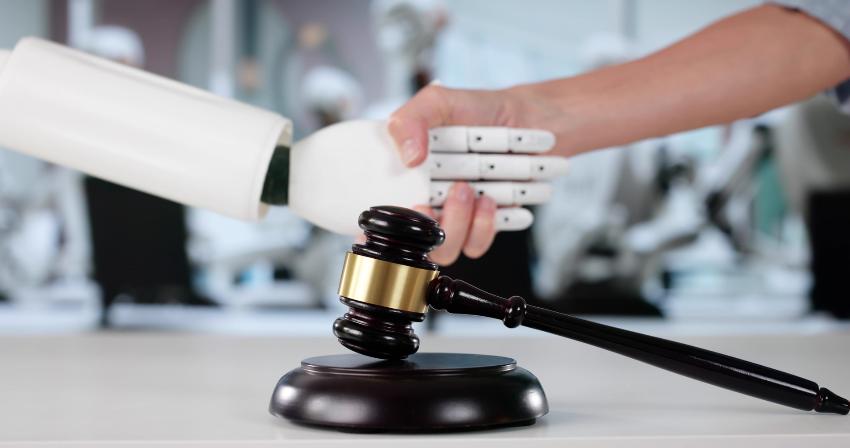 An illustration photo of a human shaking hands with an AI robot behind a gavel