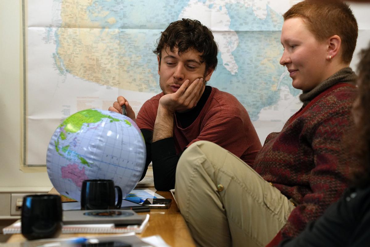 Two students looking at an inflatable earth