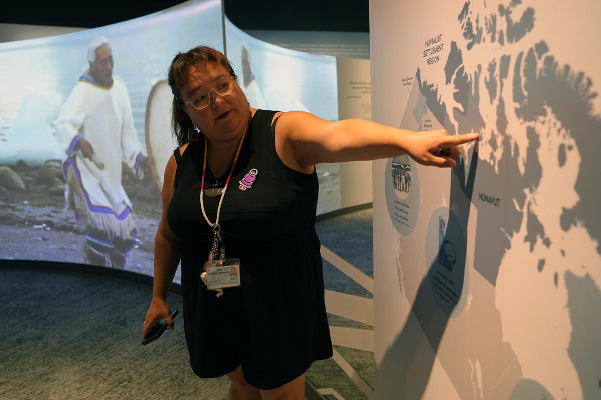 A woman showing something to a group