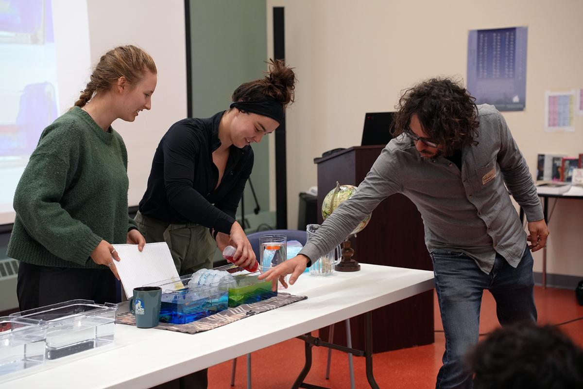 Three persons doing an experiment
