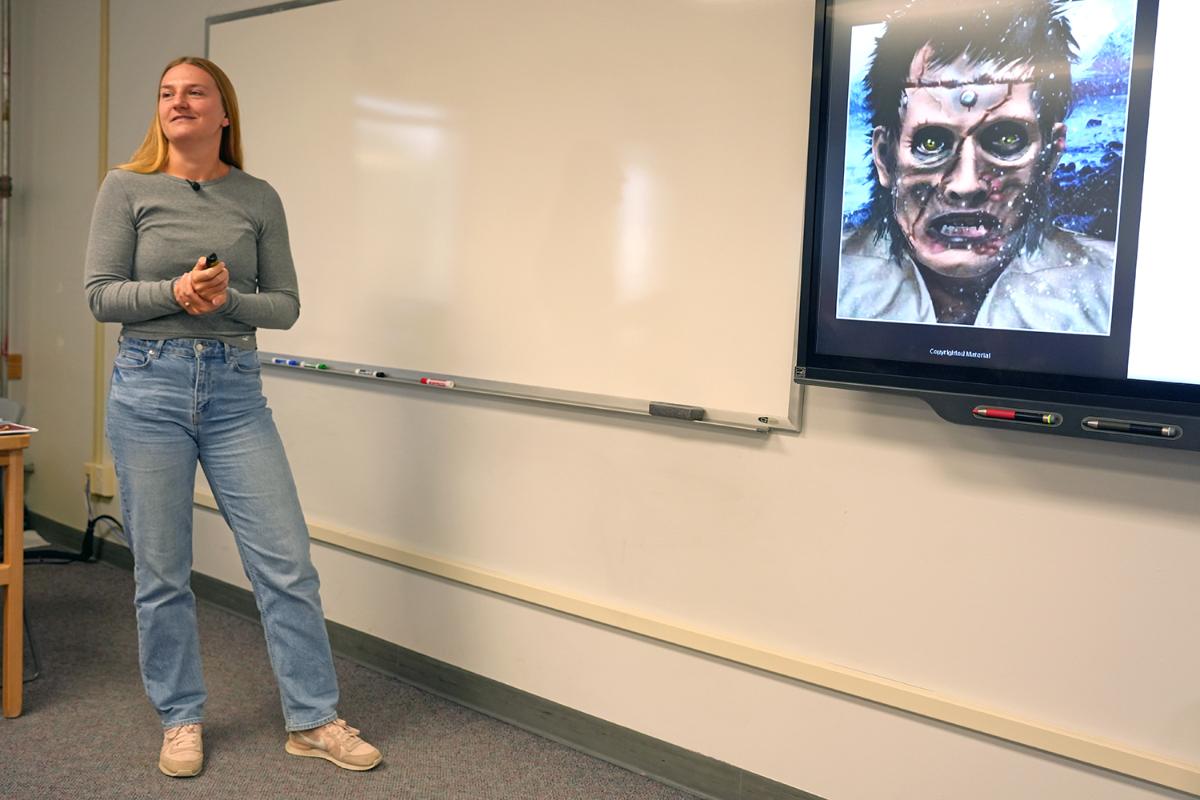 Person in front of a presentation of a book