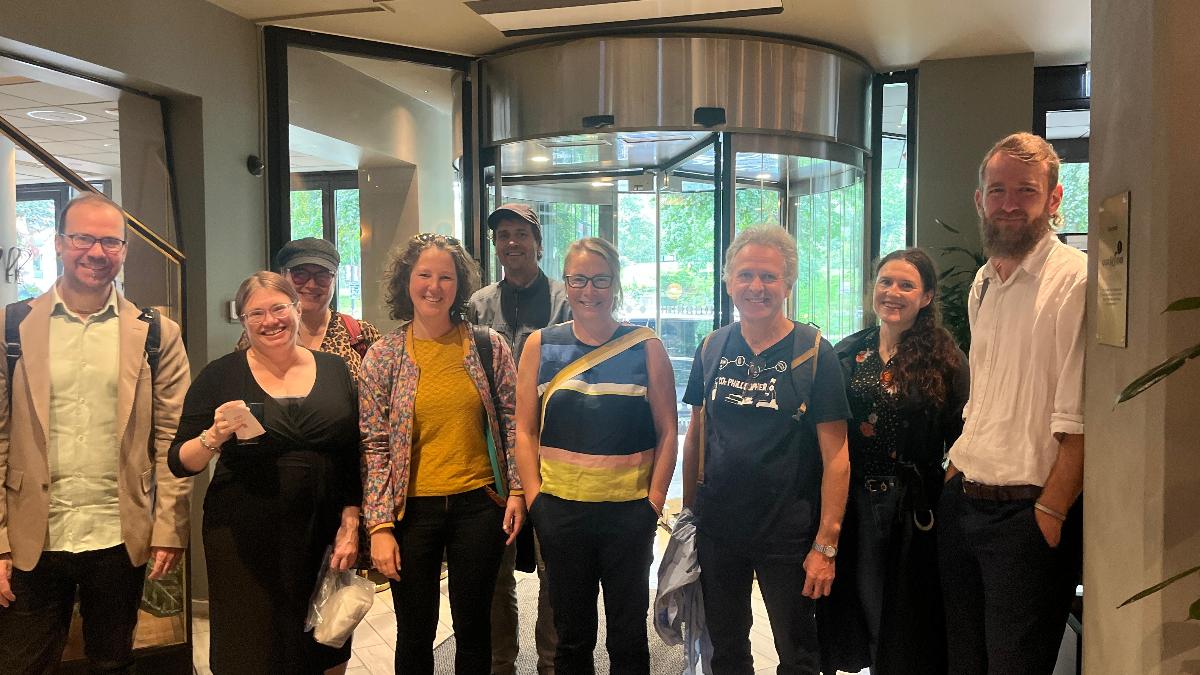 Personer samlet og smiler tilkamera