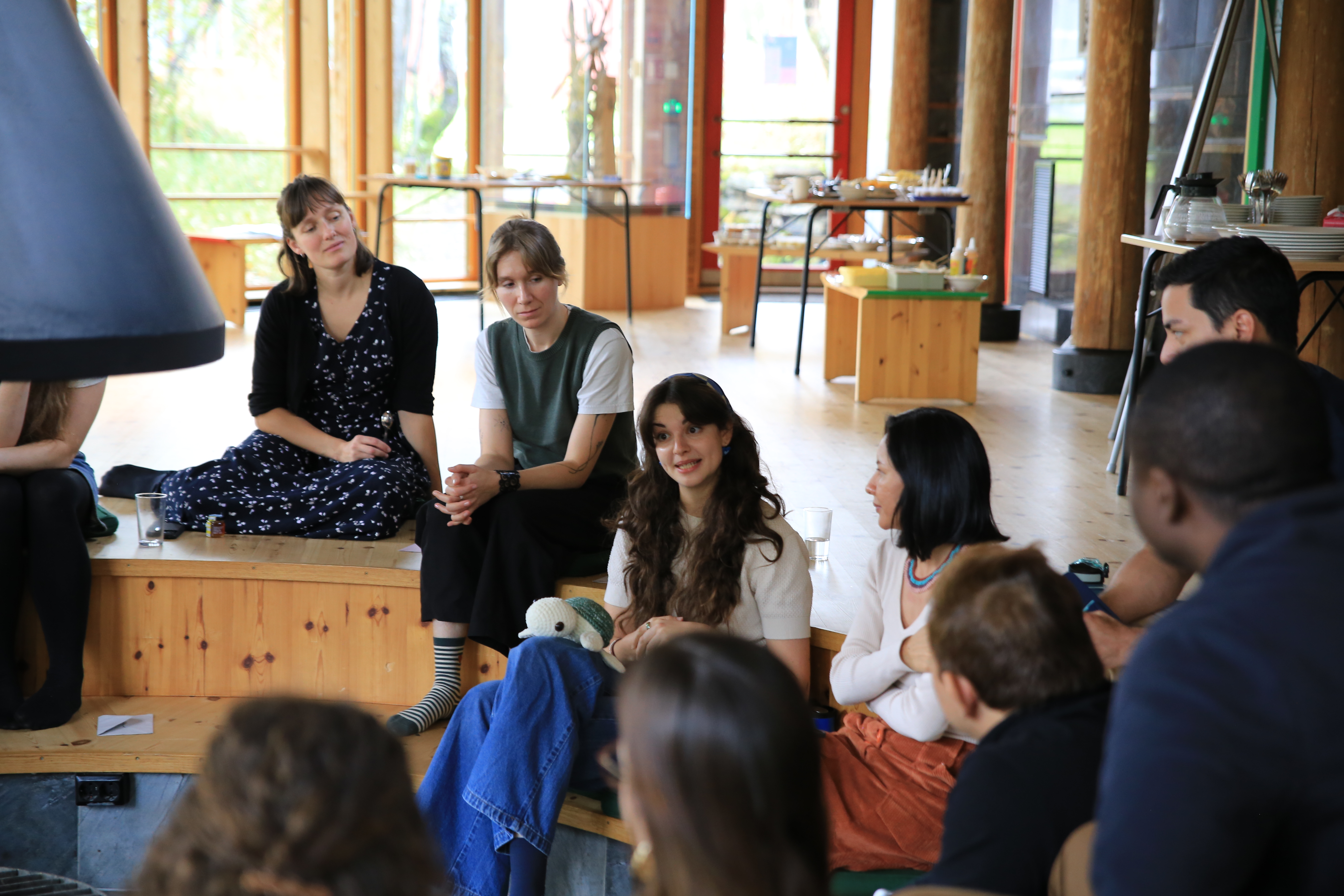 photo of people in the circle talking, focus on woman speaking