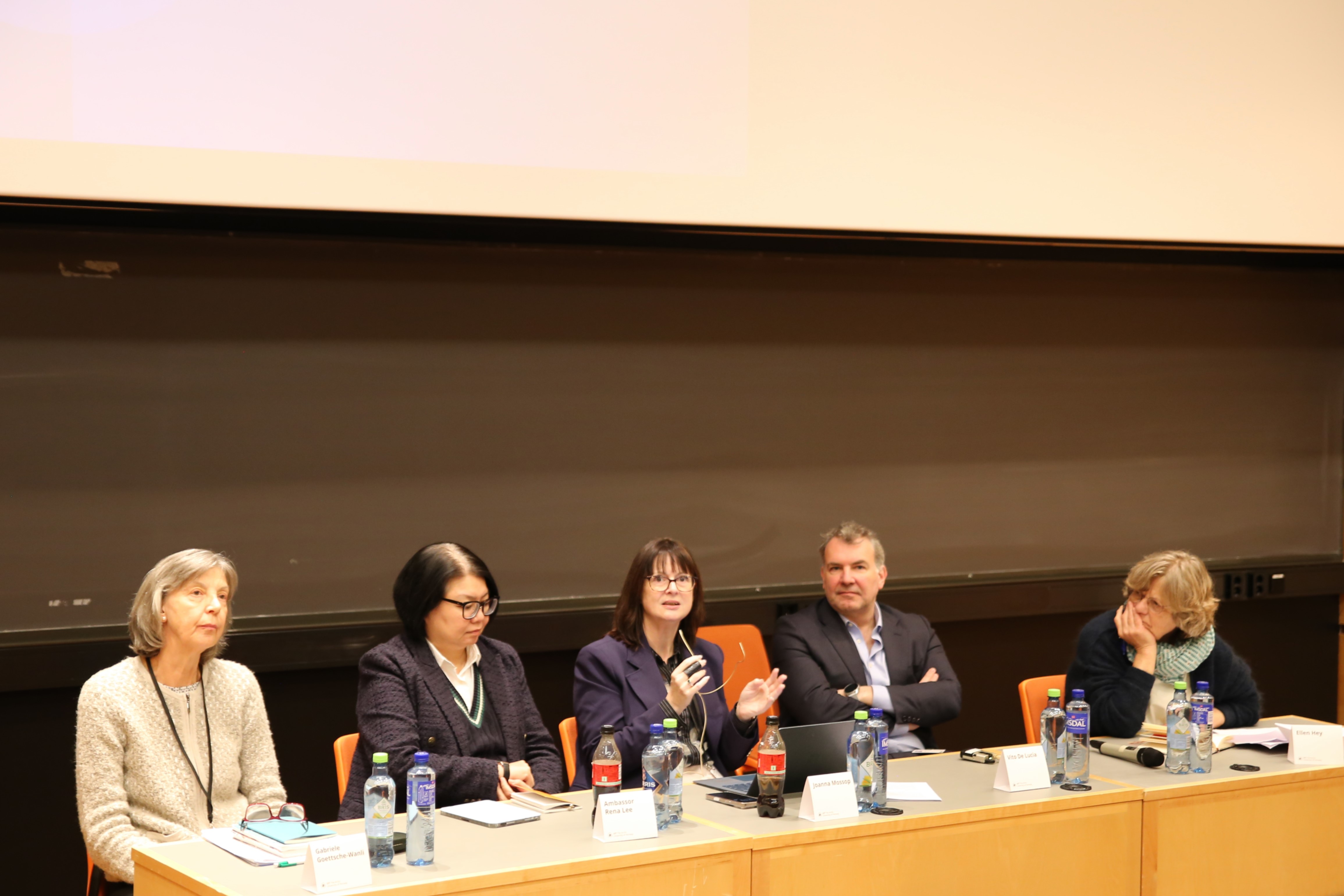 panel, three women sitting to the left, one man, then a woman to the right. 
