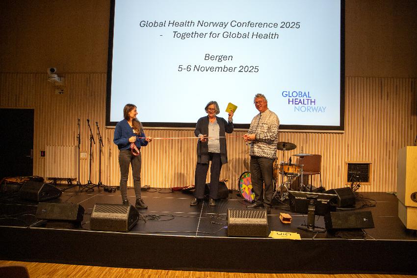 Opens the conference by cutting the ribbon