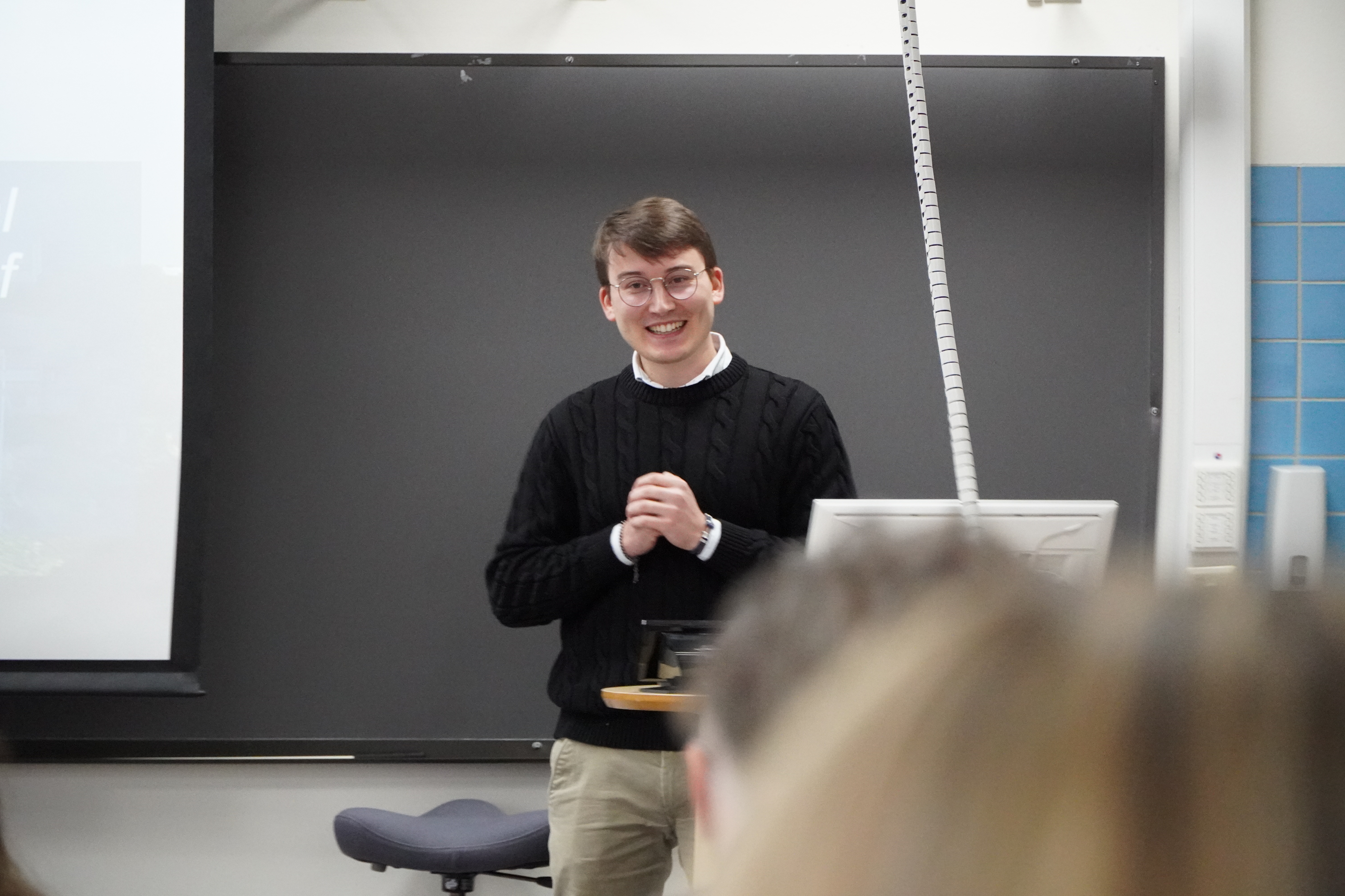 The first speaker of the second panel is smiling to the audience during his presentation