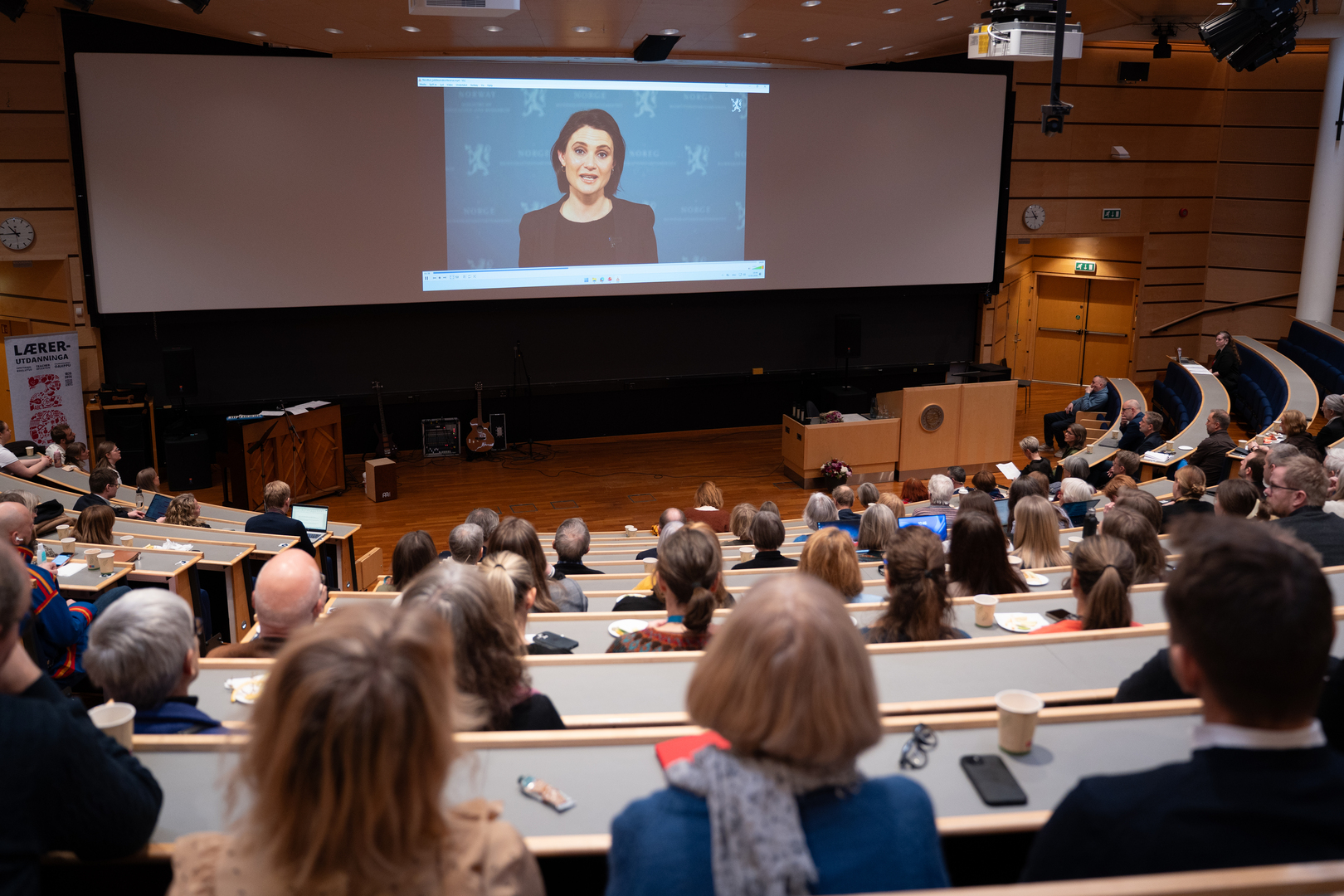 Lærer+konferansen-01014.jpg Kvinnelig minister taler på storskjerm