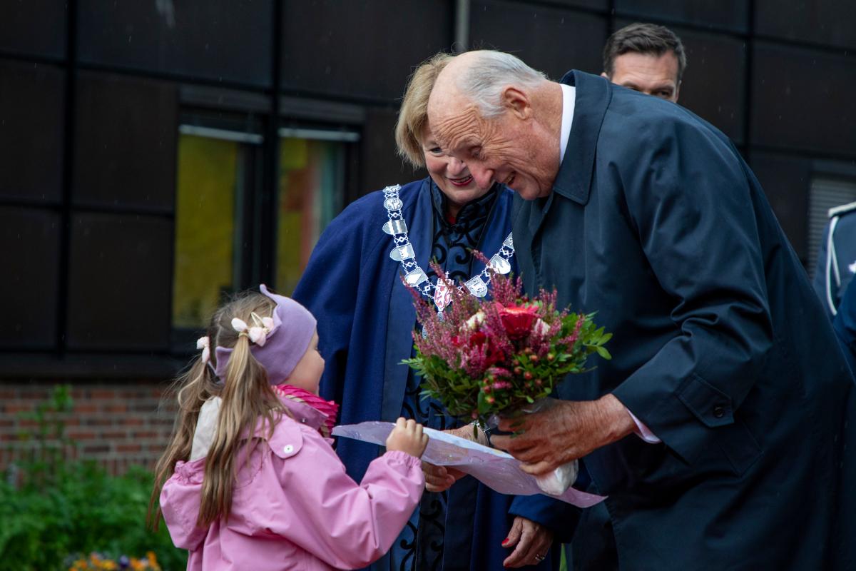King meeting a small girl that gives him flowers
